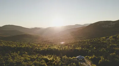 Breathtaking aerial view of sunset over lush rolling mountains in New Hampshire