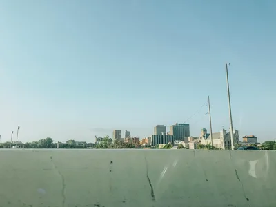 Scenic wide aerial view of downtown Dayton, Ohio skyline under a clear blue sky.