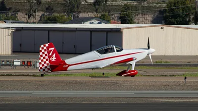 A white and red Van's RV experimental aircraft taxiing past the iconic hangars at Gillespie Field (KSEE) in El Cajon, California.