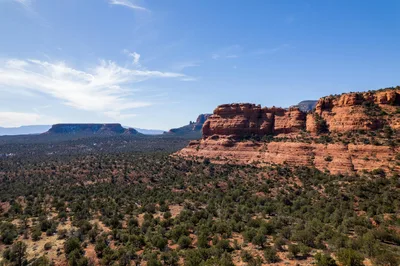 Aerial view of a flat-topped mesa and red rock formations in Sedona, Arizona.